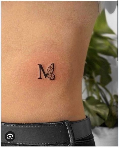 Tony Tattoo Ideas, Butterfly Tattoo With Initials, Tattoos Cartoon, Simple Tattoos For Women, M Tattoos, Small Pretty Tattoos, Petite Tattoos, Initial Tattoo, Small Wrist Tattoos