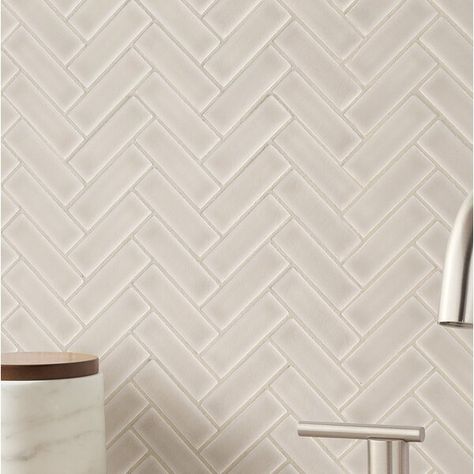 MSI’s Portico Herringbone Ceramic Mosaic Tile in Pearl/Beige strikes the perfect balance between traditional and contemporary with soothing neutral beige colorways. Combining two of today’s most sought-after looks—herringbone pattern and muted beige color—this gorgeous mosaic is destined for splendor on walls, backsplashes, shower surrounds, and other vertical spaces in residential and light commercial settings. Pair with other tiles from the Portico Collection for a cohesive look or use it alon Bathroom Tiles Beige, Brick Backsplash Kitchen, Herringbone Backsplash, Brick Backsplash, Beige Ceramic, Ceramic Mosaic, Kitchen Backsplash Designs, Ceramic Mosaic Tile, Tub Surround