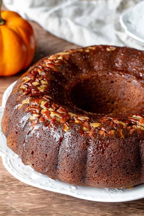 This delicious pumpkin rum cake is incredibly moist with a comforting pumpkin spice flavor. It's soaked in a butter rum sauce that complements the pumpkin perfectly to create an elevated, but simple, fall dessert. #pumpkincake #pumpkinrumcake #rumcake #falldessert #thanksgivingdessert from Just So Tasty Pumpkin Rum Cake, Butter Rum Sauce, Rum Desserts, Fall Desserts Pumpkin, Pumpkin Pecan Cobbler, Easy Bundt Cake Recipes, Autumn Treats, Rum Sauce, Baking Lessons