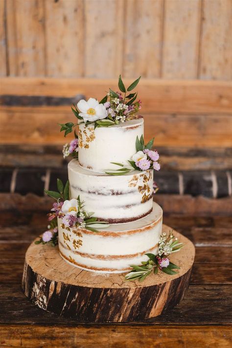 Rustic semi naked wedding cake with flowers and buttercream on a log slice cake stand www.samandlouise.co.uk Rustic Cake Flowers, Wedding Cake At Home, Rustic Tiered Cake, Rustic Carrot Cake Wedding, Wedding Cake On Log Slice, Rustic Flower Wedding Cake, Modern Rustic Wedding Cake, Rustic Wedding Cake Ideas 2 Tier, Distressed Wedding Cake