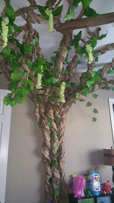 Paper tree with leaves and flowers. Rainforest toy room, game room, bedroom, nursery Jungle Theme Party Games, Rainforest Trees Crafts, Rainforest Bedroom, Rainforest Room, Rainforest Nursery, Rainforest Room Transformation, 3d Tree On Wall Classroom, Diy Jungle Vines Brown Paper, 3d Tree On Wall Classroom Paper