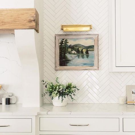 Add a pop of color and charm to your kitchen! Artwork In Kitchen, Herringbone Tile Kitchen, Cream Kitchen Walls, Herringbone Backsplash Kitchen, White Herringbone Backsplash, Cream Kitchen Tiles, White Herringbone Tile, Herringbone Tile Backsplash, Herringbone Kitchen