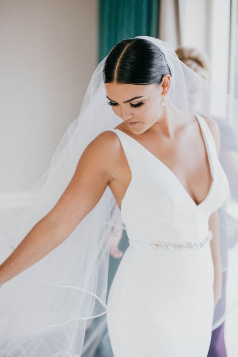 bride-in-v-neck-wedding-dress-jewel-belt-sash-middle-part-sleek-coiffure-low-bun-pretty-makeup-lash Bridal Headband With Hair Up, Wedding Hair Down Middle Part, Sleek Wedding Updo, Emerald Color Palette, Jewel Belt, Low Bun Wedding Hair, Cartagena Wedding, Morning Bun, Jeweled Wedding Dress