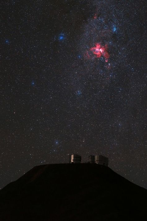 The Eta Carinae Nebula, a bright emission nebula, gives off a fiery red glow above Cerro Paranal and the VLT platform. Taken during the ESO Ultra HD Expedition. Credit: ESO/B. Tafresh Eta Carinae Nebula, Scorpius Constellation, Emission Nebula, Eta Carinae, Space And Aliens, Largest Telescope, The Milky Way Galaxy, Star Clusters, Carina Nebula