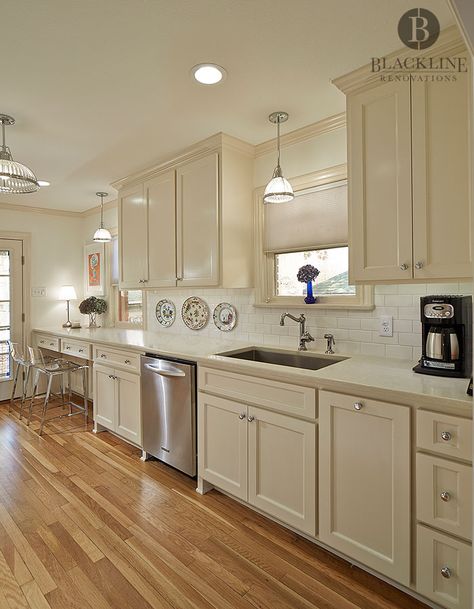 Traditional Kitchen Design by Blackline Renovations  Quartz countertops, White Subway tile, Cream cabinets, Shaker Cabinets, Timeless Design, Wood Floors Traditional Galley Kitchen, Sherwin Williams Neutral Ground, Sherwin Williams Neutral, Cream Colored Kitchen Cabinets, Cream Kitchen Cabinets, Cream Cabinets, Kitchen Remodel Countertops, Galley Kitchen Remodel, House Planning