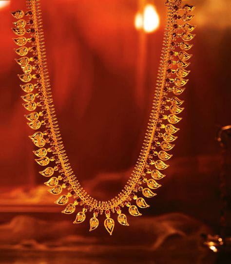 Tanishq Mangamalai, with ruby studded gold mangoes, strung together symbolizing abundance. Mango Haram Designs Gold Latest Long, Tanishq Jewellery, Latest Gold Jewellery Designs, Mango Haram, Maharashtrian Jewellery, Mango Necklace, Latest Gold Jewellery, Mango Mala, Gold Haram