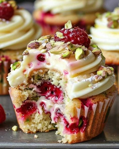 😋💚🍇 Fluffy Raspberry Pistachio Cupcakes  Ingredients: 1 1/2 cups all-purpose flour 1 teaspoon baking powder 1/2 teaspoon baking soda 1/4 teaspoon salt 1/2 cup unsalted butter, softened 1 cup granulated sugar 2 large eggs 1 teaspoon vanilla extract 1/2 cup sour cream 1/4 cup milk 1 cup fresh raspberries 1/2 cup chopped pistachios Filling: 1/2 cup raspberry jam 1/2 cup mascarpone cheese Frosting:  1/2 cup unsalted butter, softened 1/2 cup powdered sugar 1 teaspoon vanilla extract 2-3 tablespoons heavy cream Fresh raspberries and chopped pistachios for garnish Directions: Preheat the oven to 350°F (175°C) and line a muffin tin with cupcake liners. In a medium bowl, whisk together the flour, baking powder, baking soda, and salt. In a large bowl, cream together the butter and sugar until lig Fluffy Raspberry Pistachio Cupcakes, Raspberry Pistachio Cupcakes, Optimal Recipes, Raspberry Pistachio, Pistachio Cupcakes, Raspberry Cupcakes, Rich Desserts, Indulgent Desserts, Cup Cakes