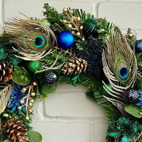 Laura Storrs on Instagram: "‘Pops’ peacock 🦚 feathers are always a hit at Christmas 🎄 #christmaswreath #colourfulchristmas #christmasinspiration #xmaswreath #wreath #peacock #peacockfeathers #peacockchristmas #peacockart #teal #navychristmas #navy" Christmas Wreath With Peacock Feathers, Wreaths With Peacock Feathers, Peacock Christmas Wreath, Wreath Peacock, Peacock Feather Wreath, Peacock Christmas, Navy Christmas, Feather Wreath, Peacock Art