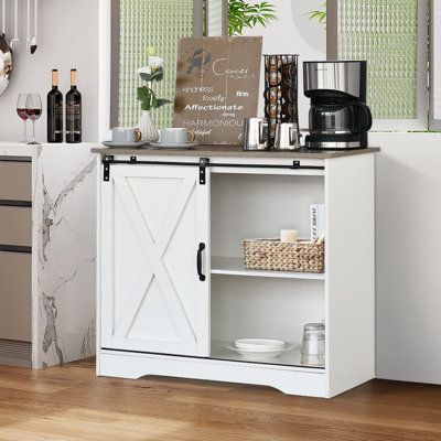 Features:This white coffee bar cabinet combines a perfectly modern style with a farmhouse design. This buffet storage cabinet is featuring a sliding barn door and rustic wood vintage color. If you want to add more farmhouse flavor to your home, this farmhouse barn door buffet coffee bar cabinet will be a great choice. This farmhouse coffee bar cabinet can blend easily all kinds of decor rooms. If you are a coffee-obsessed and cup-collecting lover, this farmhouse sliding barn door coffee bar cabi White Kitchen Sideboard, Farmhouse Coffee Station, Bar Cabinet Design, White Sideboard Buffet, Kitchen Buffet Cabinet, Grey Farmhouse, Coffee Cabinet, Coffee Bar Cabinet, Living Room Storage Cabinet