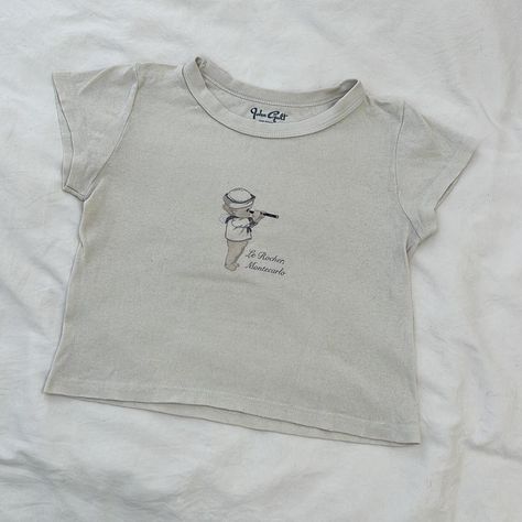 brandy melville baby tee - cherub baby, “le rocher,... - Depop Brandy Melville Baby Tee, Brandy Melville Cherub, Tinky Winky, Cherub Baby, Pink North Face, North Face Bag, Capsule Closet, Ugg Mini, Bow Bag