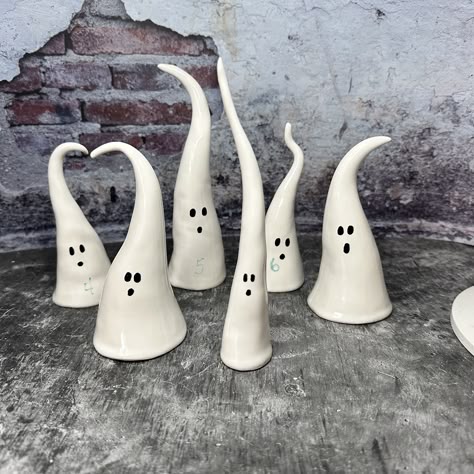 "Handmade spooky ghosts for Halloween decorating. Add some haunting spirits to your decor with these mischievous ghosts. Varied sizes, heights and widths, and assorted facial features give you plenty of choices to create the perfect tabletop scenario.  Each white ghost has eyes and mouth in black. Heights range from 5\" to 7\"  Please convo to request a possible shipping adjustment if more than one ghost is purchased.   All ghosts are handmade of stoneware clay and kiln fired for durability. The Clay Ghost Diy, Halloween Pottery Ideas, Clay Halloween Crafts, Air Dry Clay Halloween, Halloween Clay Crafts, Halloween Clay Ideas, Ceramic Ghosts, Clay Ghosts, Ghosts For Halloween