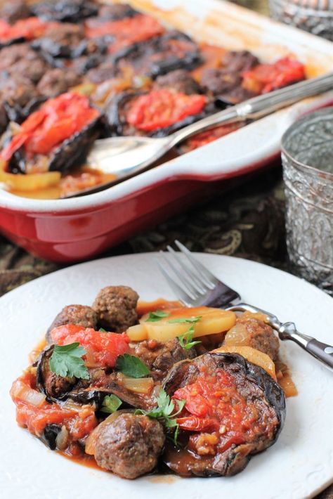 Luscious, silky eggplants, tender potatoes, and flavourful meatballs braised in a light tomato sauce; Tepsi Baytinijan is a traditional Iraqi comfort food dish. #EatTheWorld #eggplant #healthyrecipe Light Tomato Sauce, Iraqi Cuisine, Eggplant Casserole, Eggplant Dishes, Middle Eastern Dishes, Stewed Potatoes, Eastern Cuisine, Food Challenge, Middle Eastern Recipes