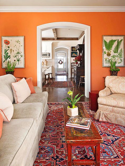 Even traditionally minded decor can benefit from a jolt of unexpected wall color. Here, a bright spice orange infuses a classic living room with energy. The color is used in small doses throughout the room so the wall color doesn't appear as an afterthought. The Color: Bryce Canyon -- Benjamin Moore Orange Wallpaper Living Room, Unique Paint Colors, Baltimore House, Orange Living Room, Orange Paint Colors, Colorful Walls, Orange Rooms, Happy Room, Living Room Orange