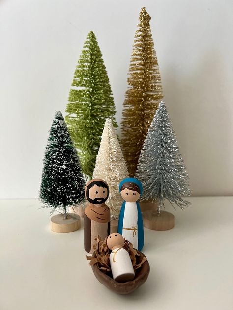 Jesus is the reason for the season!  This beautiful, handmade and simple nativity set is the perfect Christmas addition to remember the reason why we celebrate Christmas.  All pieces are hand painted with non-toxic paint and lots of love! The cradle is made out of clay and all pieces are sealed. *Please note, each set is hand painted. Your set may have slight variation to color or design. I always do my best to duplicate the original design. May be a choking hazard for children under 2. Peg Dolls Nativity Set, Nativity Peg Doll, Simple Nativity, Christmas Addition, Peg People, The Cradle, Non Toxic Paint, Doll Set, Peg Doll