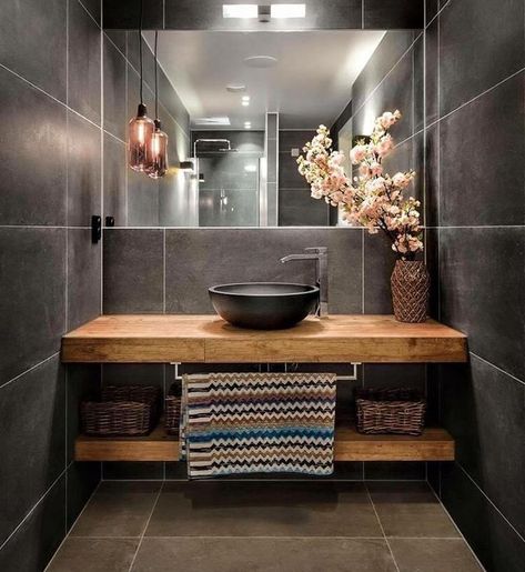 Sleek black tiles and a warm wood counter are complimented by the light pink blossoms, amber pendant light and wall-width mirror. Drømme Bad, Koti Diy, Bilik Air, Bad Inspiration, Wooden Vanity, Small Remodel, Gorgeous Bathroom, Wooden Bathroom, Trendy Bathroom