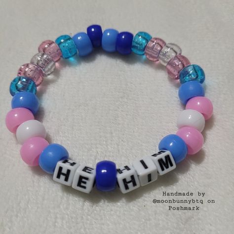 Glittery And Solid Beads In The Trans Flag Colors Pony Bead Pronoun Bracelet "He/Him" With Light Blue And Dark Blue Bead Accents Double Stranded Elastic Kandi Bracelet Perfect For Emo, Scene, Y2k, Rave, Festival, Goth, Pastel Goth, Egirl, Gamer, Lgbt Pride Aesthetics. Elastic Bracelet Has Fair Stretch. Model Wrist 6.5" Model Hand 7.5" Please Check Measurements For Both. Please Do Not Exceed 8" Width, Elastic Will Break More Sizes Will Be Included Soon. Stock And Supplies Are Limited. Original Ha Single Kandi Bracelets Ideas, Trans Kandi Bracelet, Weird Core Bracelets, Simple Kandi Bracelets, Blue Kandi Bracelets, Bracelet Patterns Pony Beads, Trans Kandi Cuff, Christmas Kandi Bracelets, Pride Bracelet Ideas