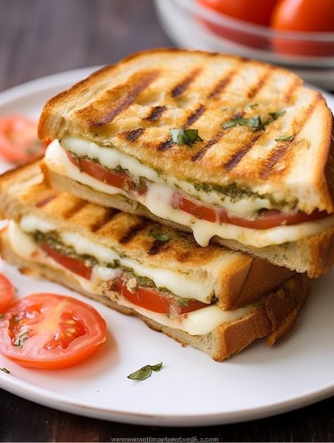 Featuring a medley of fresh mozzarella, juicy tomatoes, and aromatic basil pesto stylishly sandwiched between golden brown sourdough, this Crisp and Melty Caprese Panini is your ticket to a quick and divine gourmet sandwich creation at home which is ready in less than 15 minutes. Caprese Panini, Tomato Mozzarella Basil, Mozzarella Sandwich, Pesto Cheese, Gourmet Sandwiches, Tomato Mozzarella, Gooey Cheese, Green Bean Recipes, Juicy Tomatoes