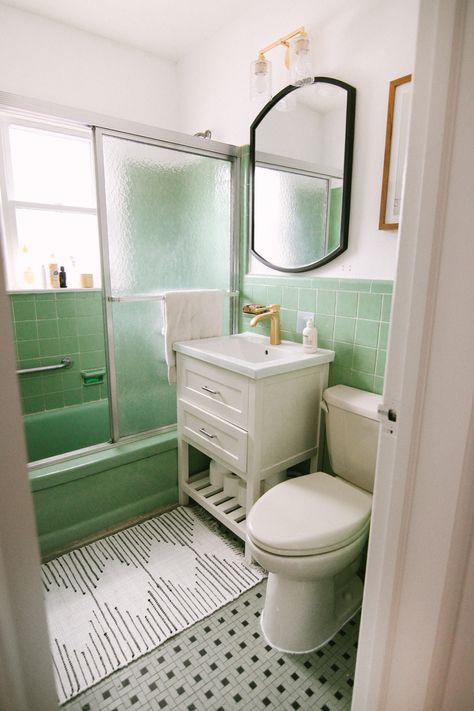 When we bought this home, I knew that the mint tile was here to stay. I also knew it couldn’t stay as-is – the sink was super retro and scalloped, and made the bathroom feel dingy and outdated. I wanted to brighten up the space by painting it white, and adding in an updated and more modern feeling white vanity. I was so excited to partner with Wayfair to find everything, including this gold faucet which is now my pride and joy!   To start, we ripped out the old vanity, mirror and light fixtur... Green Tile Bathroom, Mid Century Bathroom, Retro Bathrooms, White Appliances, Room Remodel, Vintage Bathrooms, After Pictures, Bathroom Redo, Bathroom Update