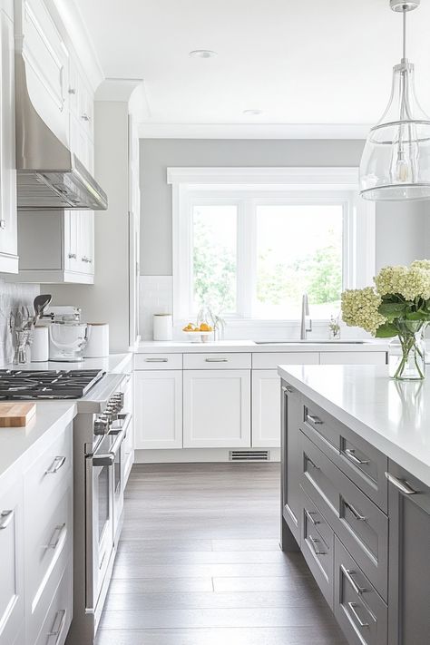 Modern, bright kitchen with white cabinetry, stainless steel appliances, and a large window over the sink. White And Gray Kitchen Decor, Gray Kitchen Decor Ideas, Modern Grey And White Kitchen, Grey And White Kitchen Decor, Grey And White Kitchen Ideas, White Kitchen Decor Ideas, Gray Kitchen Decor, Geometric Tile Backsplash, White And Gray Kitchen