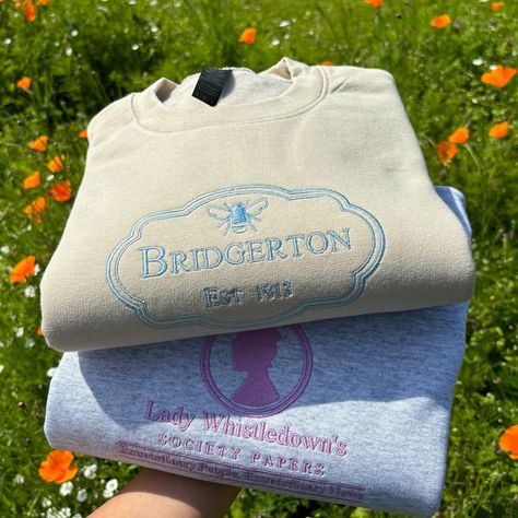 FINALLY 🪻💕🌸 I’ve had a fair few requests for Bridgerton sweatshirts and here we are 🩷 I love them so much! The thread colours are fully customisable for these 🫶🏼✨ #embroidery #smallbusiness Disney Embroidery Designs Sweatshirts, Embroidery Inspiration Clothing Sweatshirts & Hoodies, Bridgerton Shirt Ideas, Bridgerton Merch, Bridgerton Merchandise, Kpop Diy, Embroidered Hoodie, Embroidered Sweatshirts, Custom Embroidery