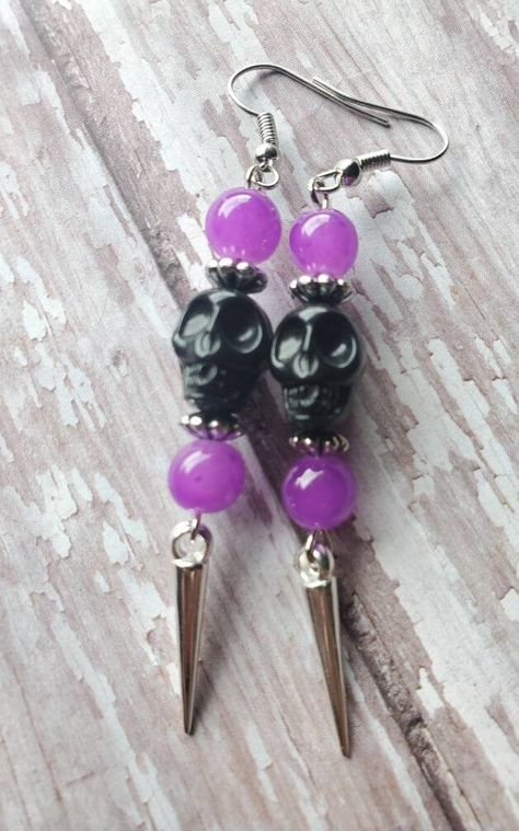 FREE DOMESTIC SHIPPING ONLY Please read the shipping, policies, and procedures Handmade with lots of love! Spooky cool black skull earrings accompanied by purple glass rounds, designer silver spaces, and silver dangling spike. The earrings dangle at 3.25 inches (1cm in width), very light weight. The black skulls have intricate detailing and the earrings are created with silver tone plated precious metals. These earrings make a great fashion statement, especially for Halloween. The earrings are r Halloween Earrings Diy, Alt Jewelry, Black Beaded Earrings, Spooky Jewelry, Statement Earrings Silver, Purple Drop Earrings, Happy Halloweenie, Earrings Gothic, Witch Earrings