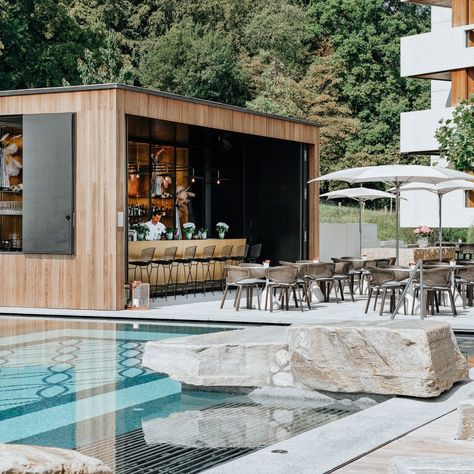 We designed a pool and a pool bar for the Atlantis hotel in Zurich. The minimalistic appearance of the pool area reflects the architecture of the Zurich swimming events from the 60s and 70s. Bar Area Outdoor, Outdoor Pool Bar Design, Swimming Pool Bar Design, Pool Restaurant Design, Hotel Pool Bar Design, Hotel Pool Area Design, Pool Club Design, Pool Cabana Bar, Pool Side Restaurant