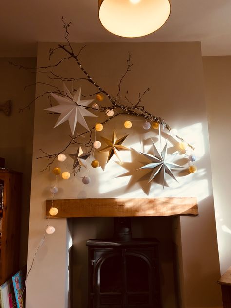 Ikea Strala Star Ideas, Office Christmas Decorations Wall, Modern Fireplace Christmas Decor, Christmas Paper Wall Decor, Christmas Home Decoration, Star Lantern Decor, Christmas Lights Living Room, Paper Star Garland Christmas, Paper Star Wall Decor