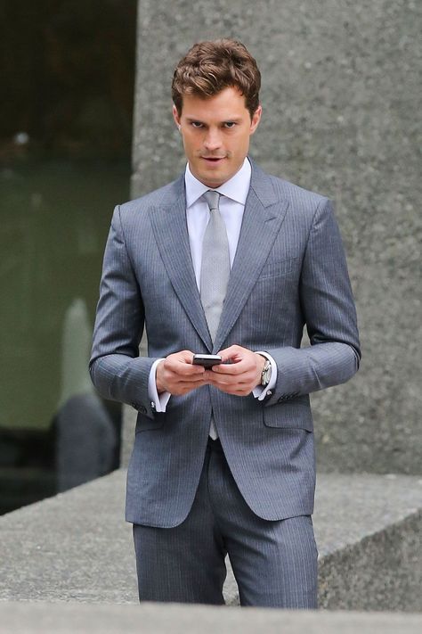 New pictures from the 50 Shades set- CosmopolitanUK Christian Gray Fifty Shades, Christian Grey Jamie Dornan, A Man In A Suit, Man In A Suit, Fifty Shades Movie, How To Look Handsome, 50 Shades Of Grey, Christian Grey, Gray Suit