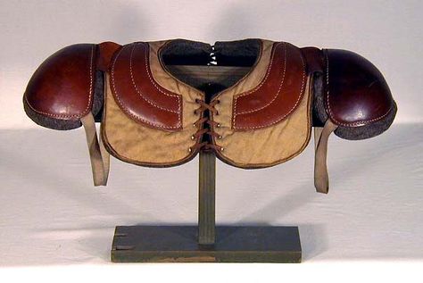 1910's Quilted Leather Football Shoulder Pads. Made by the Thomas E. Wilson Sporting Goods Company, these are a very early and uncommon style of shoulder pads. The body of the pads are made of canvas with protective leather on the top which has been quilted through to the bottom, or inside, wool padding. $500 Football Shoulder Pad, Rugby Body, Vintage Sports Decor, Football Shoulder Pads, Old Football, Football Pads, American Football Uniform, Wilson Sporting Goods, Football Uniform