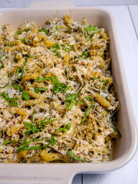 This Pesto Pasta Chicken Bake with shredded juicy chicken, mixed with pesto, and baked to golden brown cheesy perfection. An easy and flavorful dinner for the family. #pastabake #pesto #pestosauce #pestopasta #pestochicken #casserole #dinnerrecipe #easymeal #pesto #shreddedchicken Shredded Chicken Pesto Pasta, Chicken Pesto Bake, Pesto Chicken Rice Bake, Pesto Chicken Pasta Casserole, Cheesy Pesto Chicken Bake, Chicken Pasta Bake, Pesto Chicken Pasta, Pasta Casserole, Rotisserie Chicken Recipes