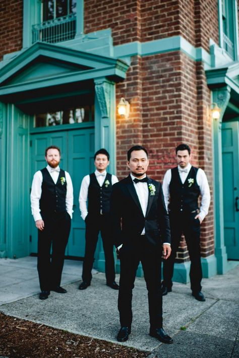 Groom and groomsmen look great in black tie! Suit With Bow Tie, Black Three Piece Suit, Groomsmen Vest, Casual Groom Attire, Wedding Groomsmen Attire, Casual Grooms, Rustic Elegant Wedding, Groomsmen Outfits, Handsome Groom