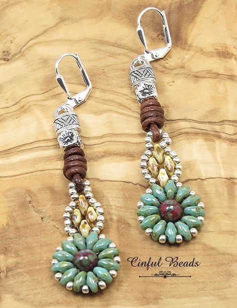 "THIS LISTING IS FOR THE EARRINGS ONLY This unique pair of Southwestern boho beaded earrings are sure to get you compliments!  Turquoise picasso superduos surround a red picasso round Czech glass bead to form a floral design. Beige picasso superduos have been added in a diamond shape and accented with silver seed beads. This hangs on natural brown round leather cord with a barrel knot and a floral cube spacer bead. The leather cord is glued into antique silver Tibetan style cord ends. Choose lev Barrel Knot, Cord Earrings, Beaded Patterns, Southwestern Boho, Cottage Grove, Jewerly Beads, Bead Projects, Leather Corded Necklace, Cord Ends