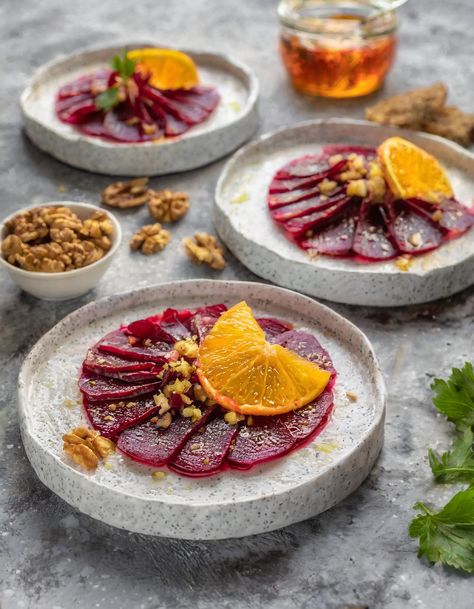 Savor the vibrant colors and fresh flavors with this Beet Carpaccio with Orange Vinaigrette, an elegant starter that pairs the earthy sweetness of beets with a zesty orange dressing. Topped with toasted walnuts, this dish offers a delightful crunch and nuttiness that complements the soft texture of the beets perfectly. Beet Salad Plating, Beetroot Carpaccio Fine Dining, Beet Cured Salmon, Fine Dining Recipes Vegetarian, Amous Bouche Ideas, Beetroot Canapes, Best Vegan Dishes, Vegan Fine Dining Dishes, Cold Starters Fine Dining