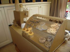 Cardboard Cafe for Kids Cardboard Cafe Diy, Cardboard Play Food Diy, Cardboard Shop Diy, Cardboard Kitchen Diy For Kids, Cardboard Starbucks, Cardboard Restaurant, Cardboard Box Ideas For Kids, Carbord Craft, Cute Cardboard Crafts