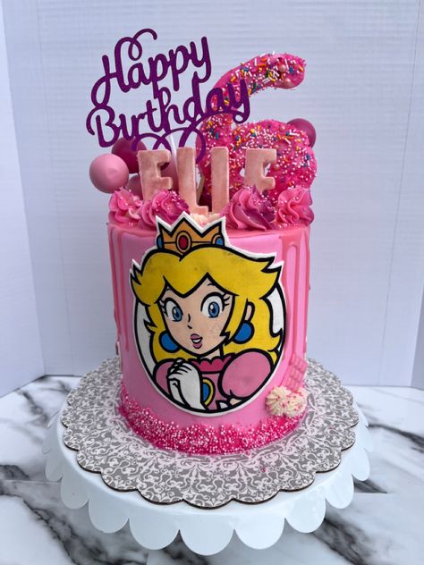 Princess Peach! A super fun birthday cake for a princess who turned 6! A three layer GF pink vanilla cake filled with milk chocolate and strawberries and topped with vanilla buttercream. And some chocolate toppers of course! Princess Peaches Cake, Princess Peach Cake Birthdays, Pastel Princesa Peach, Princess Peach Cake Topper, Princess Peach Cake, Princess Peach Birthday, Double Barrel Cake, Princess Peach Party, Chocolate Toppers