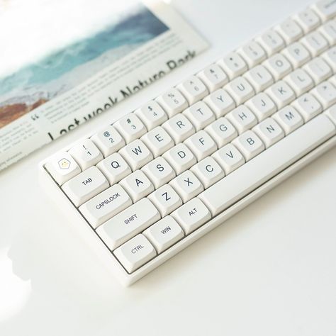 Please accept this white minimalism. Different from the cliche black, this white is clear, natural, fresh, and clean. It is undoubtedly an excellent match for typing or gaming, allowing you to isolate all impurities and focus on this moment on the keyboard only. #minimalist #white #keycap #keycaps #keycapset #mechkeyboard #mechkeyboards #officelife #officespace #officedecor #pcsetup #gamingsetup #gamingsetups #gamingsetupidea #keyboard #keycapss Fancy Keyboard, Key Cap, Key Caps, Minimalist White, Ipad Stand, Pc Setup, Fresh And Clean, Gaming Setup, This Moment