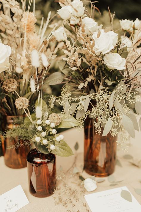 Black Taupe And Greenery Wedding, Boho Neutral Centerpieces, Simple Boho Bridal Shower Centerpieces, Jug Centerpiece Wedding, Norse Wedding Decor, Simple Boho Wedding Centerpieces, Amber Vases Wedding Centerpieces, Fall Wedding Decorations Diy, Dried Flowers Wedding Centerpieces