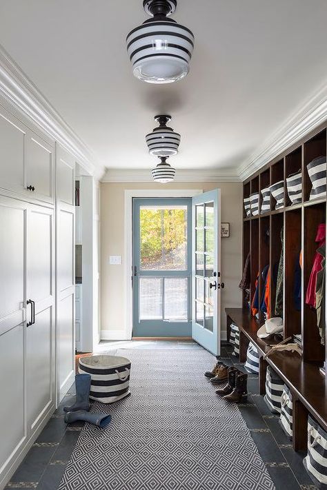 lighting Long country style mudroom features a wall lined with open stained mudroom lockers accented with rugby stripe bins from the Container store both below each seat and above on the top of each shelf for extra storage and enhanced organization. Transitional Laundry Room, Farmhouse Mudroom, Laundry Room/mud Room, Mudroom Lockers, Mudroom Ideas, Mudroom Entryway, Mudroom Decor, Farmhouse Entryway, Mudroom Design