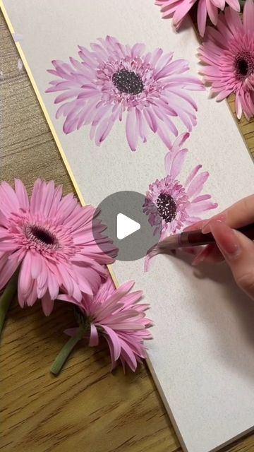 Watercolor Art Gallery on Instagram: "This beautiful floral artwork captures the vibrant essence of pink gerbera daisies in full bloom. The artist carefully applies strokes of delicate pinks and purples, bringing the petals to life with each motion. The contrast between the painted flowers and the real blossoms placed beside them highlights the skill in creating lifelike texture and dimension. It’s a perfect example of how nature’s beauty can be recreated with artistic precision.

Painting by @asiahwabang
. 
.
. 
#watercolor #watercolors #watercolorpainting #watercolorart #gouache #aquarelle #resim #watercolor_daily" Gerbera Daisy Painting, Pink Gerbera, Gerbera Daisies, Daisy Painting, Natural Flowers, Gerbera Daisy, Floral Artwork, Pink Daisy, Painted Flowers