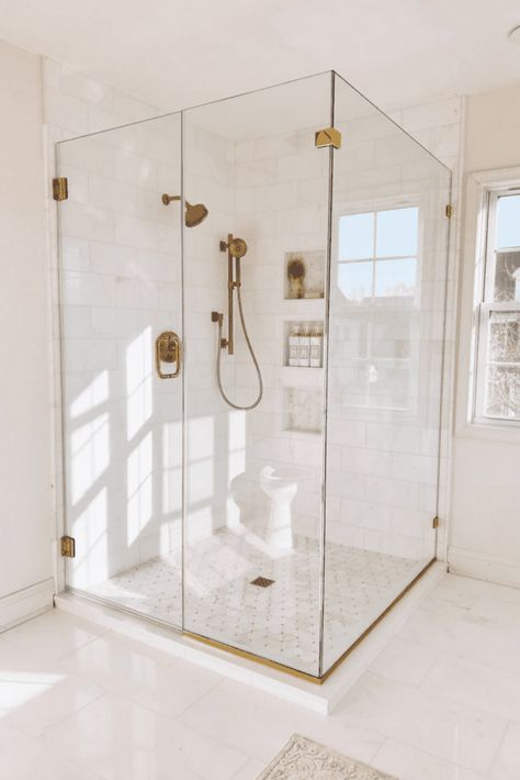 Glass Shower With Gold Hardware, Glass Shower Door Gold Hardware, White And Gold Modern Bathroom, Glass Shower Gold Hardware, All Glass Shower Doors, White Bathroom With Gold Hardware, Gold Hardware Shower, Floor To Ceiling Shower Doors, Big Glass Shower Master Bath