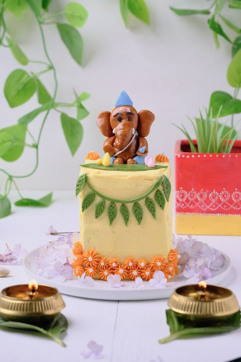 The Ganesh Chaturthi Bento Cake is a visually appealing dessert designed to resemble Lord Ganesha and incorporate elements of the festival. It is typically a cake that is artfully decorated to resemble an idol of Lord Ganesha, placed within a bento-style box or platter for added flair. The cake is usually sculpted and shaped to form the body of Lord Ganesha, with attention to detail given to his distinctive features, such as his elephant head, trunk, and arms. Ganesh Ji Clay Art, Ganesha Model With Clay, Ganesha By Clay, Ganesh Modak Cake Design, Clay Ganapati Idol, Quick Nail Art, Quick Nail, Ganesh Ji, Bento Cake