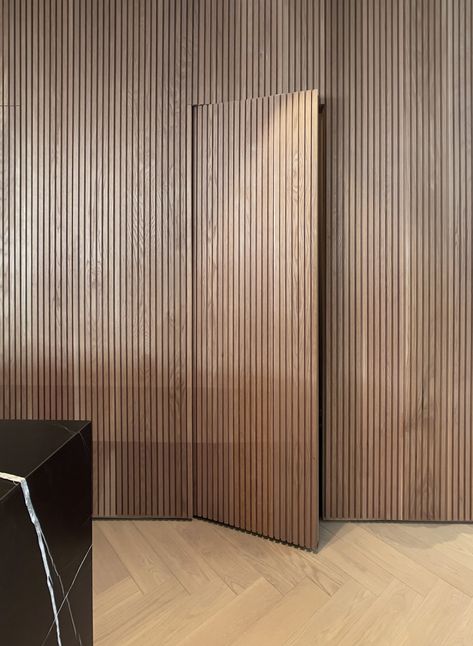 Wood Slat Wall Ceiling, Wall Panel With Concealed Door, Door Concealed In Panelling, Slatted Wood Wall Interior, Timber Panelling Wall Interiors, Japandi Wood Slat Wall, Hidden Door Cladding, Wooden Slat Wall Hallway, White Slate Wall