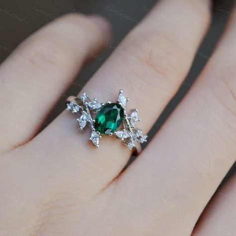 Beautiful Natural Inspired emerald ring, elegant engagment ring, unique anniversary gift. Material: 925 sterling silver, plated with white gold. Main Stone: Lab Created Emerald Measurement: 5*7 mm Cut: OvalCut Side Stone: CZ Band Width: Approximately 1.7 mm CS0394 Custom order accepted, if need different stone or material, just feel free to contact.:) Home page: https://www.etsy.com/shop/CarrieStudio?ref=seller-platform-mcnav Emerald Engagement Ring With Silver Band, Engagement Rings With Emeralds Side Stones, White Gold And Emerald Ring, Emerald Rings Aesthetic, Emerald Crystal Ring, Wedding Rings Engagement Emerald, Ring With Emerald, Promise Ring Emerald, Wedding Rings Green Emerald