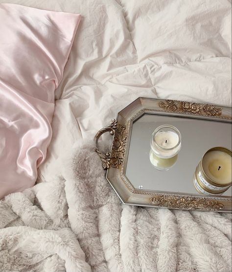 Pink satin pillow covers with a white duvet, plush off white blanket, and ornate gold mirrored tray with candles. Satin Pillows Aesthetic, Satin Bedsheets Aesthetic, Silk Bedding Set Aesthetic, Satin Bedding Aesthetic, Silk Sheets Aesthetic, Silk Bed Sheets Aesthetic, Silk Bedroom, Scented Candles Aesthetic, Breakfast In Bed Tray