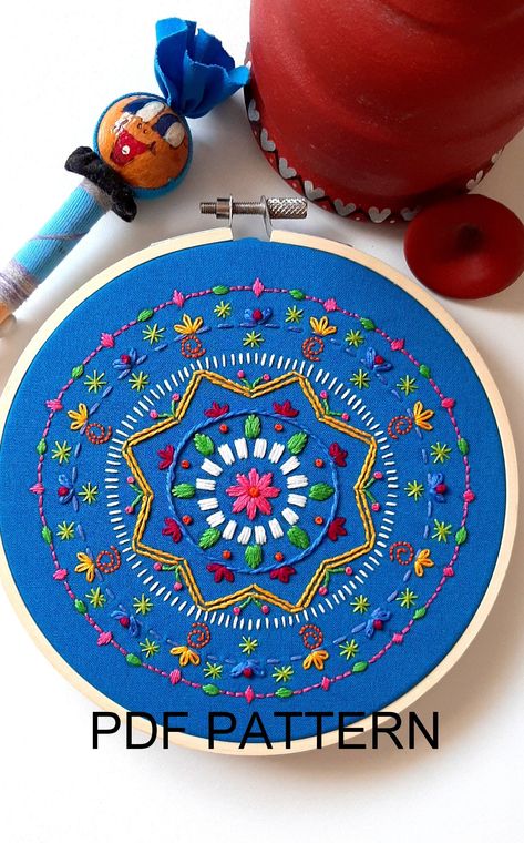 The colours used in this design are bright and cheerful, and appear jewel-like on the blue fabric! This mandala will brighten up any room or shelf in your home. This mandala pattern is ideal for beginners and is downloaded automatically upon payment. The basic stitches are easy to master and the repetition of the elements provides ample opportunity to practice new embroidery skills. Stitching instructions and hints and tips on how to complete the project are also provided.  I hope you enjoy maki Mandala Embroidery Design, Embroidery On Blue Fabric, Beginning Embroidery, Embroidered Mandala, Mandala Embroidery, Clothes Embroidery Diy, Beginner Embroidery, Textile Art Embroidery, New Embroidery