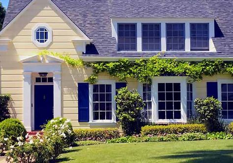 Pale yellow cottage-style home with blue door and shutters and white trim Yellow House Exterior, Exterior Paint Combinations, Shutter Colors, Best Exterior Paint, House Paint Color Combination, House Shutters, Yellow Cottage, Blue Shutters, Exterior House Paint Color Combinations