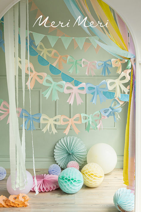 Pastel bow garlands hanging with other tissue paper bunting and honeycomb decorations. Meri Meri Garland, Pastel Party Backdrop, Surprise Birthday Decorations, Baby Deco, Pastel Bows, Paper Balloon, Pearl Party, Photoshoot Backdrops, Garland Backdrops