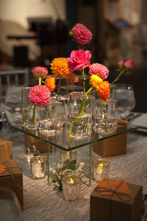 Pink And Orange Flower Centerpieces, Pink And Orange Centerpieces, Pink And Orange Wedding Flowers Centerpieces, Pink Purple Orange Centerpiece, Roses And Dahlias, Shades Of Pink And Orange, Dahlia Centerpiece, Glass Vases Wedding, Bud Vases Wedding