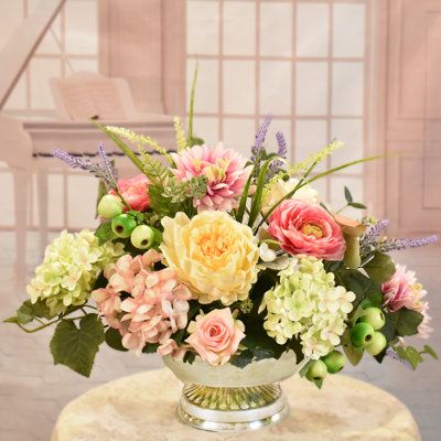 Our designers choose a soothing combination of flowers and hues in soft pinks and greens for this design. Set this beautiful silk floral centerpiece just about anywhere to add color and elegance to your home or office. Created with peonies, ranunculus, soft green and pink hydrangeas, mini roses, berries and foliage. Set in a silver metal low pedestal bowl. Perfect for a dining table, coffee table, dresser, an event or party. | Primrue Faux Silk Arrangement in Vase in Pink | 15" H X 20" W X 14" D Low Bowl Floral Arrangement, Floral Centerpieces For Dining Table, Summer Floral Centerpieces, Pink Hydrangea Centerpiece, Pink Hydrangea Centerpieces, Spring Flower Arrangements Centerpieces, Ranunculus Centerpiece, Silk Floral Centerpiece, Seasonal Plants