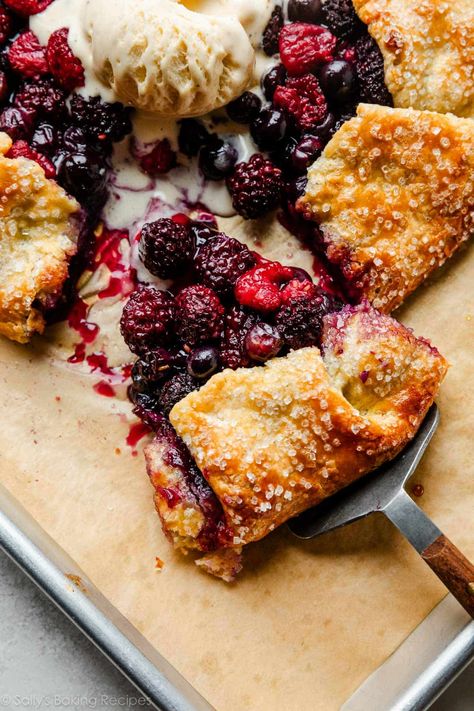 This berry galette is as delicious as berry pie, but takes half the time and effort. This easy yet impressive dessert is complete with a thick and flavorful homemade crust made with buttermilk and cornmeal, and, of course, a scoop of vanilla ice cream! Recipe on sallysbakingaddiction.com Berry Galette, Cornmeal Crust, Blueberry Galette, Pie Crust From Scratch, Impressive Dessert, Homemade Crust, Vanilla Ice Cream Recipe, Impressive Desserts, Sally's Baking